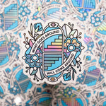 A 3.4x3.3" holographic vinyl art sticker of a symmetrical illustration of opposing arches with staircases that lead up or down surrounds by flowers. Banner are protruding from the arches in a circular composition that read: What goes around will come around. Drawn in a flash tattoo and pop art fusion style in a cyan, white and black color palette by the artist, Red Halftone.